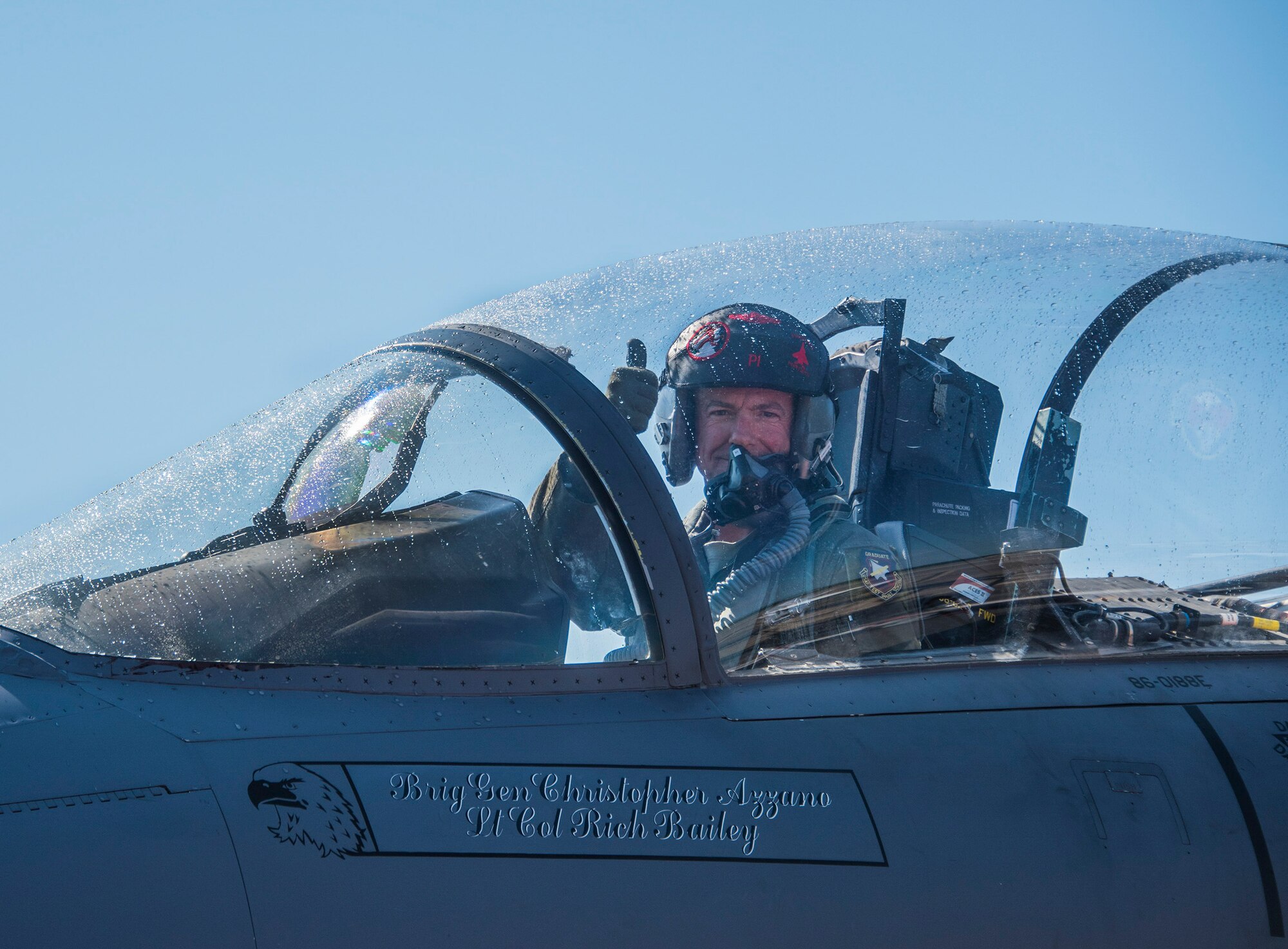 Brig. Gen. Christopher Azzano, 96thTest Wing commander, signals aircraft maintainers during his fini flight at Eglin Air Force Base, Fla. May 15. The fini flight is a symbol of a member’s final flight with the unit or base. Azzano’s new assignment will take him to Wright-Patterson Air Force Base in Ohio to take command of the Directorate of Air, Space and Cyberspace Operations. (U.S. Air Force photo/Ilka Cole)