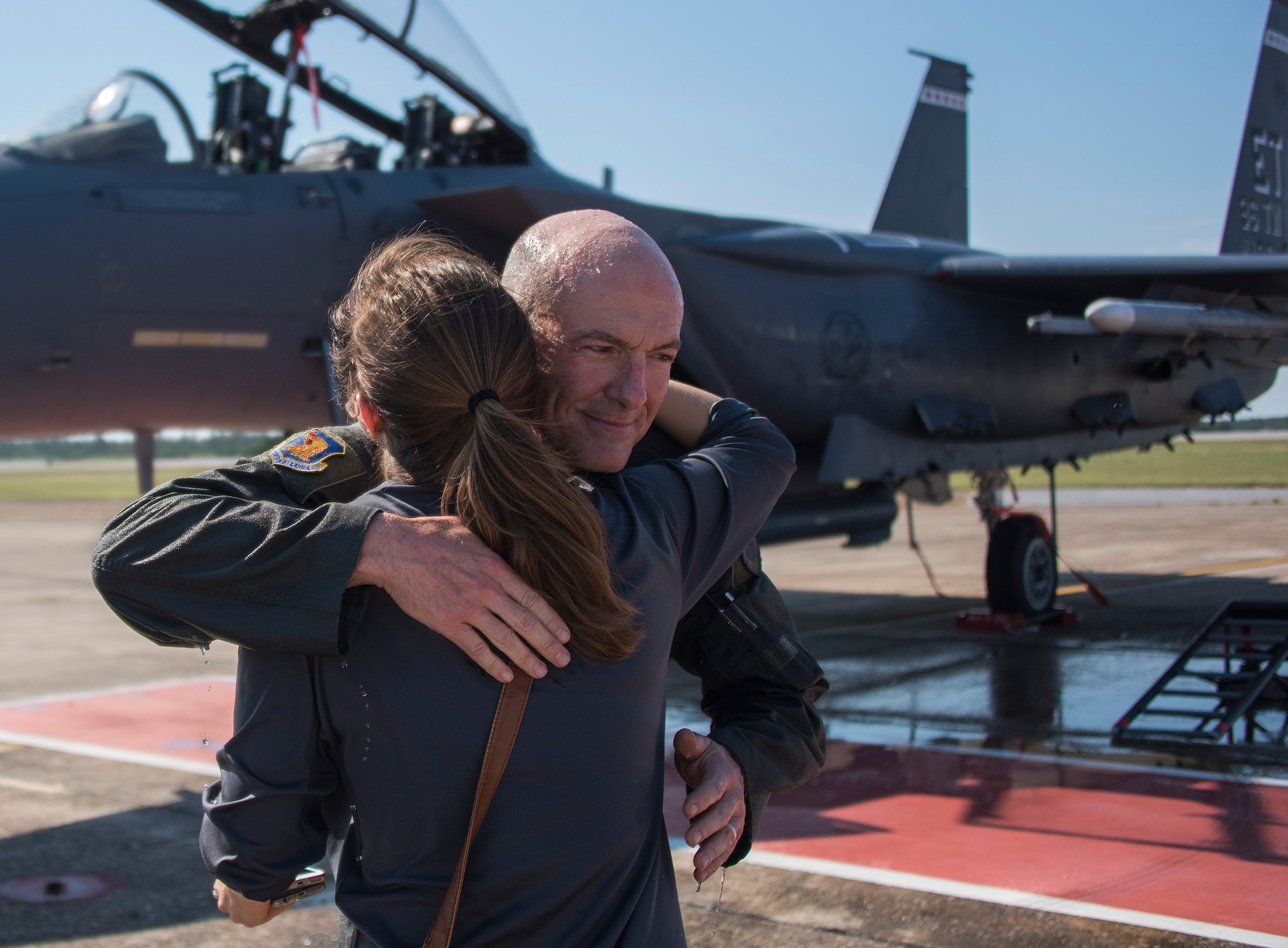 Brig. Gen. Christopher Azzano, 96th Test Wing commander, hugs his daughter, Ali, during his fini flight at Eglin Air Force Base, Fla. May 15. The fini flight is a symbol of a member’s final flight with the unit or base. Azzano’s new assignment will take him to Wright-Patterson Air Force Base in Ohio to take command of the Directorate of Air, Space and Cyberspace Operations. (U.S. Air Force photo/Ilka Cole) 