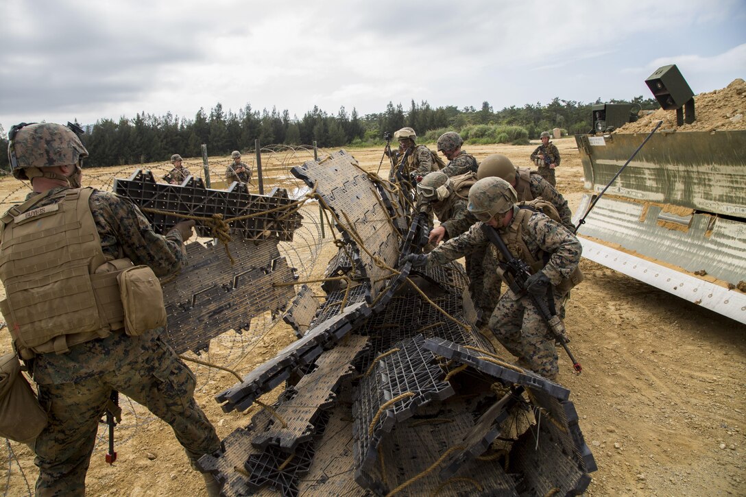 U.S. Marines with 3D Marine Logistics Group, III Marine Expeditionary Force, conduct obstacle breaching training on Camp Hansen, Okinawa, Japan, May 11, 2017. This exercise was conducted to increase the Marines’ engineering proficiency in a combat environment. (U.S. Marine Corps photo by Lance Cpl. Jesus McCloud)