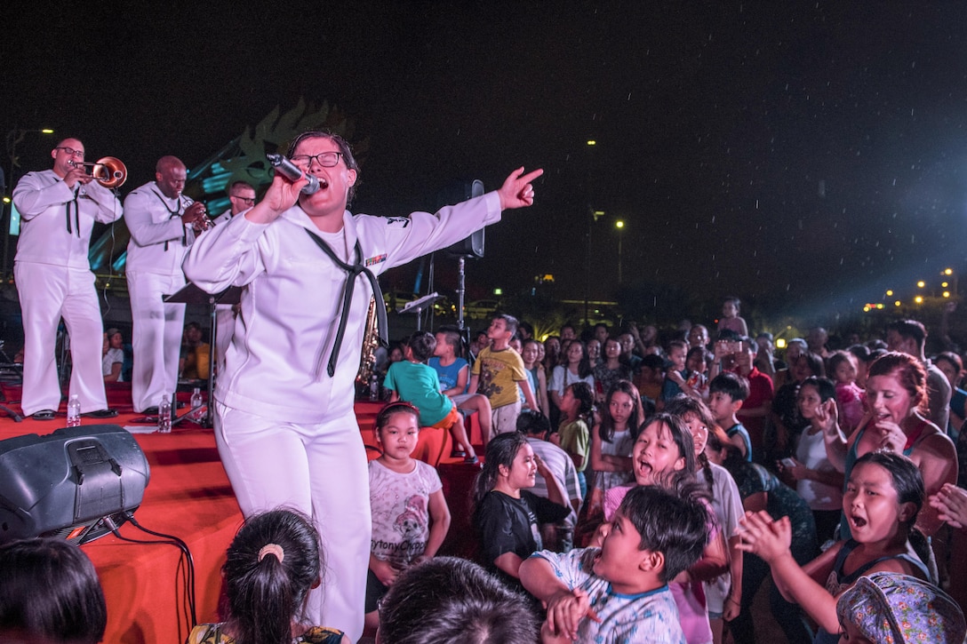 Navy Petty Officer 3rd Class Emileigh Kershaw performs at the Dragon Bridge in Da Nang, Vietnam, May 13, 2017, during Pacific Partnership 2017. Pacific Partnership is an annual multilateral humanitarian assistance and disaster relief preparedness mission conducted in the Indo-Asia-Pacific region. Navy photo by Petty Officer 2nd Class Joshua Fulton