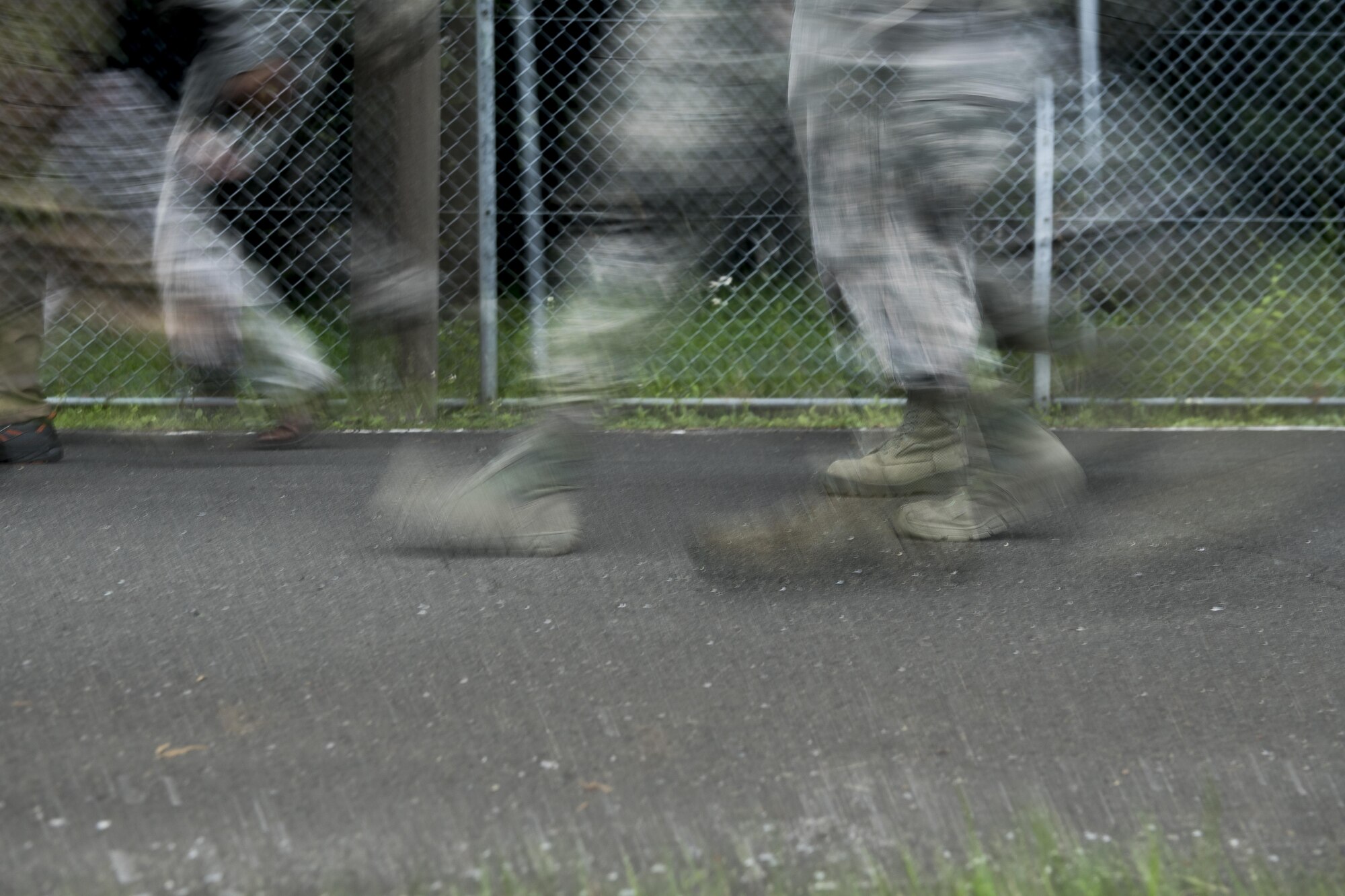 Participants in the Memorial 5K Ruck March walk along the road, May 15, 2017, at Yokota Air Base, Japan. The Memorial 5K Ruck March had approximately 75 participants from the 374 SFS, Office of Special Investigations and various members of base leadership. (U.S. Air Force photo by Airman 1st Class Donald Hudson)