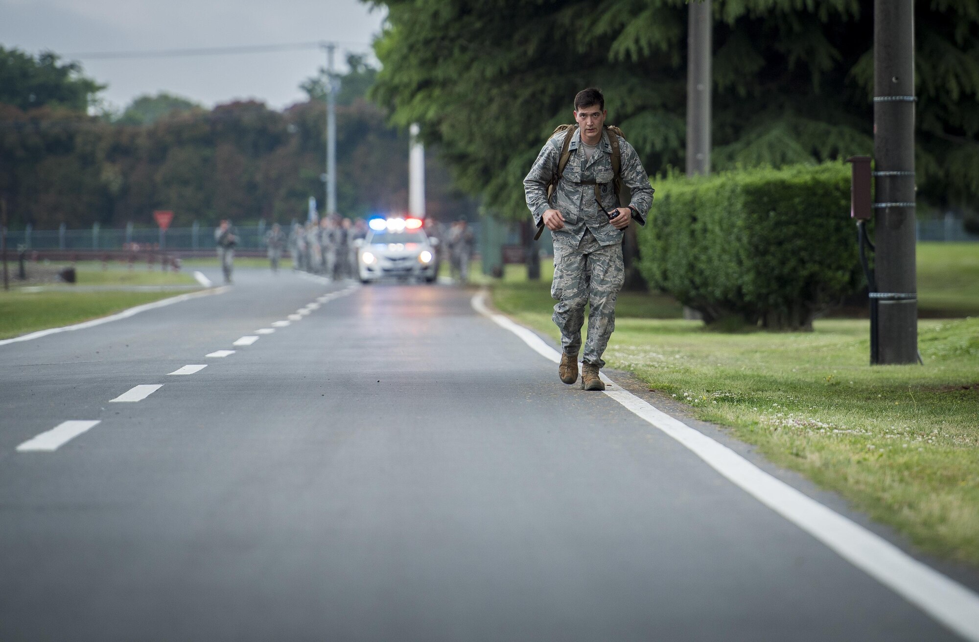 Capt. Michael F. Winter, 374th Security Forces Squadron commander, runs ahead of the group during the Memorial 5K Ruck March, May 15, 2017, at Yokota Air Base, Japan. The participants in the Memorial 5K Ruck March were weighed down by 35 pound packs. (U.S. Air Force photo by Airman 1st Class Donald Hudson)