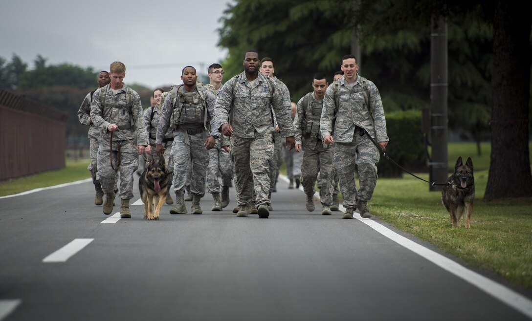 Participants in the Memorial 5K Ruck March lead the group with accompanying 374th Security Forces Squadron K-9 units, May 15, 2017, at Yokota Air Base, Japan. The Memorial 5K Ruck March was in remembrance of all the Security Forces and law enforcement members that were killed in the line of duty. (U.S. Air Force photo by Airman 1st Class Donald Hudson)
