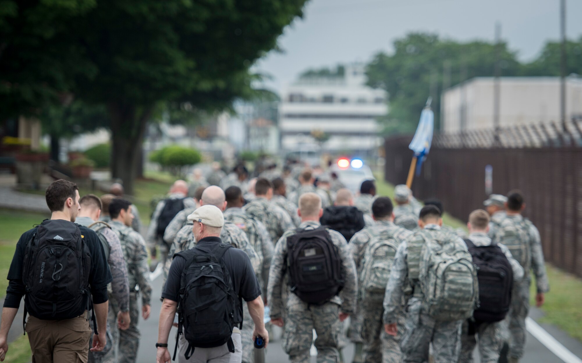 Participants fill the road during the Memorial 5K Ruck March, May 15, 2017, at Yokota Air Base, Japan. The participants in the Memorial 5K Ruck March were weighed down by 35 pound packs. (U.S. Air Force photo by Airman 1st Class Donald Hudson)