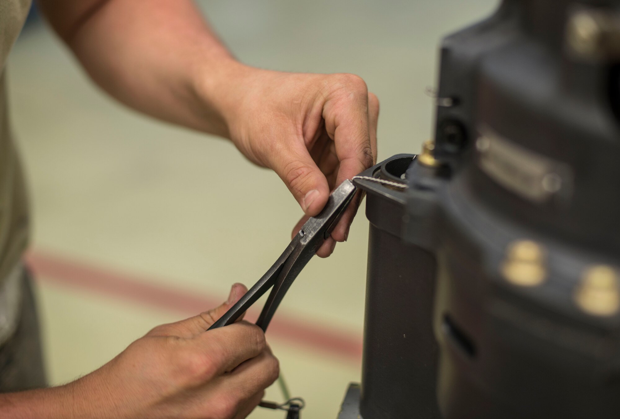 U.S. Air Force Senior Airman Joshua Wood, a 35th Maintenance Squadron armament technician, tightens a wire on a M61A1 20mm Gatling Gun at Kunsan Air Base, Republic of Korea, May 15, 2017. Wood along with other Airmen performed an 18-month inspection on the system ensuring all the components were in working order. Every 18-months they completely break down the M61A1 20mm Gatling Gun and rebuild it, repairing or replacing any components. (U.S. Air Force photo by Senior Airman Brittany A. Chase)