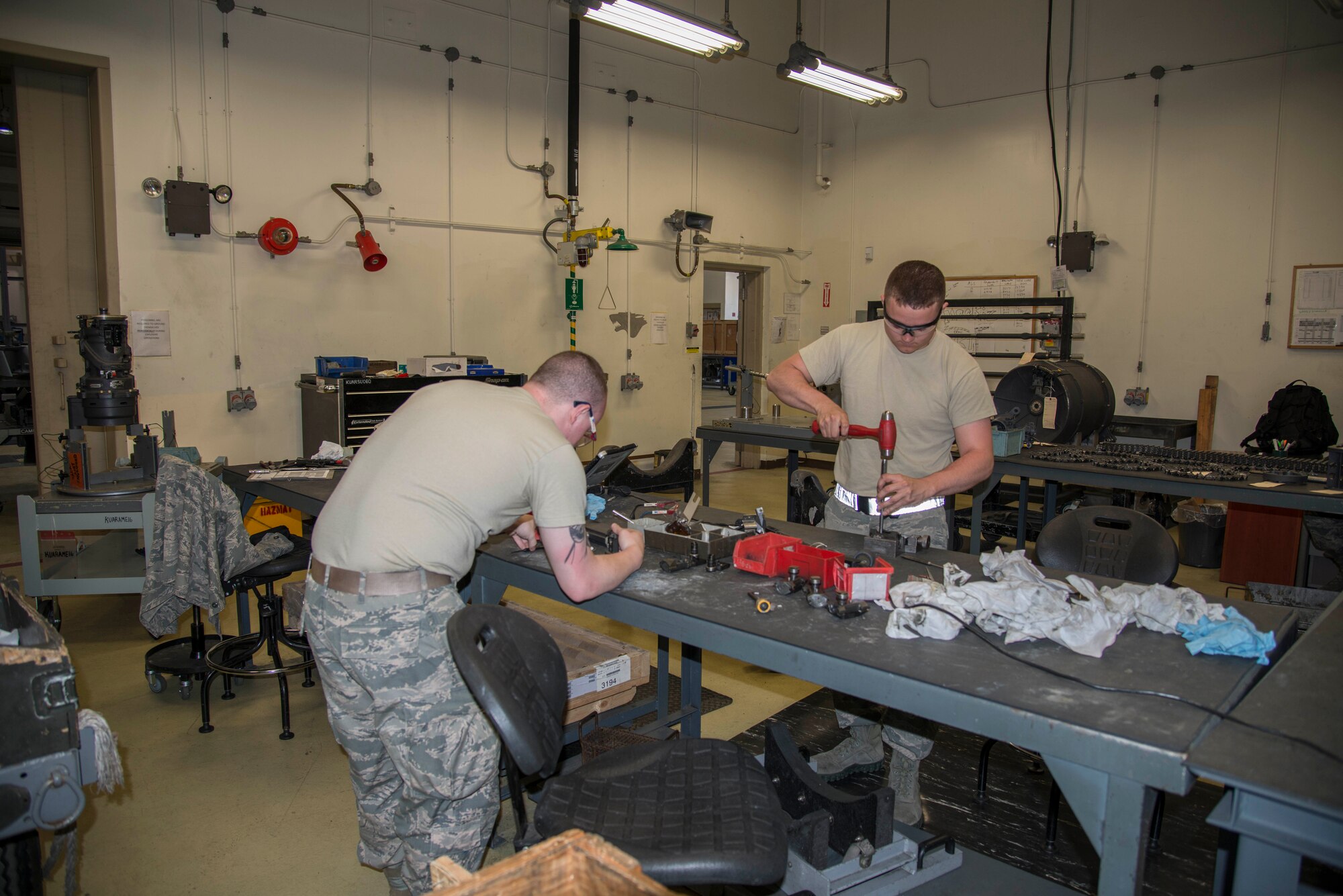 U.S. Air Force Senior Airman Joshua Wood and Airman 1st Class John Williams, both 35th Maintenance Squadron armament technicians, work on breach bolts at Kunsan Air Base, Republic of Korea, May 15, 2017. Breach bolts pull the round into the rotor, pulling it forward so it can fire then pull it back. This was a part of an 18-month inspection where they completely break down the M61A1 20mm Gatling Gun and rebuild it, repairing or replacing any components that have been damaged. (U.S. Air Force photo by Senior Airman Brittany A. Chase)
