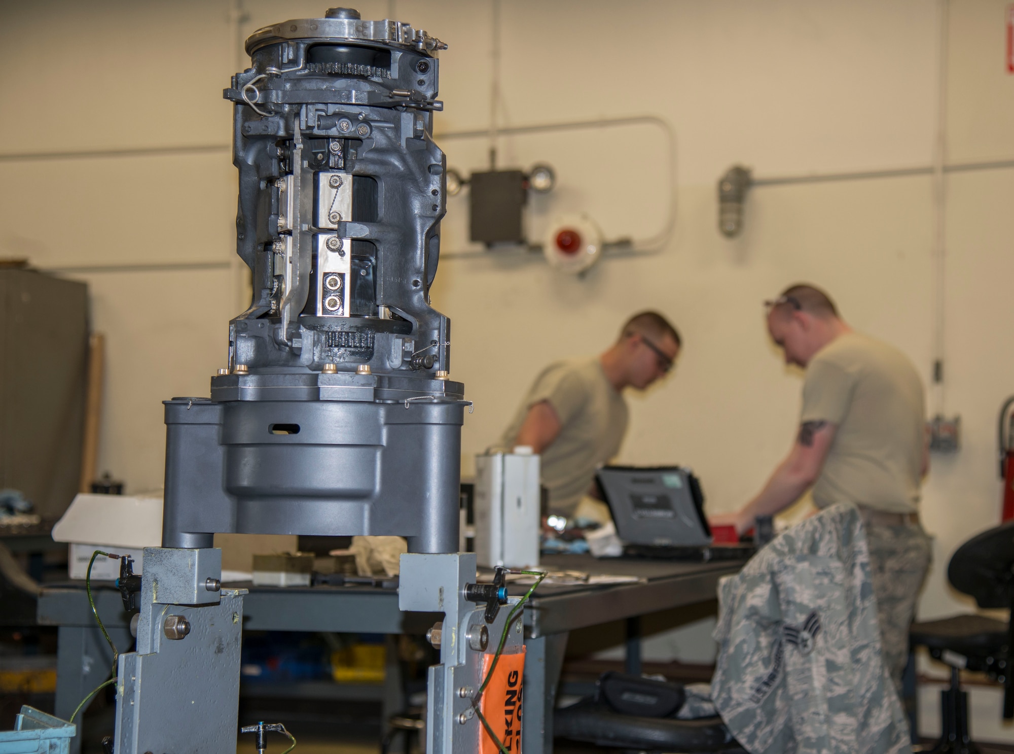 A M61A1 20mm Gatling Gun sits on a stand while U.S. Air Force Senior Airman Joshua Wood and Airman 1st Class John Williams, both 35th Maintenance Squadron armament technicians, work on breach bolts at Kunsan Air Base, Republic of Korea, May 15, 2017. Breach bolts pull the round into the rotor, pulling it forward so it can fire then pulls it back. This was a part of an 18-month inspection where they completely break down the M61A1 and rebuild it, repairing or replacing any components that have been damaged. (U.S. Air Force photo by Senior Airman Brittany A. Chase)