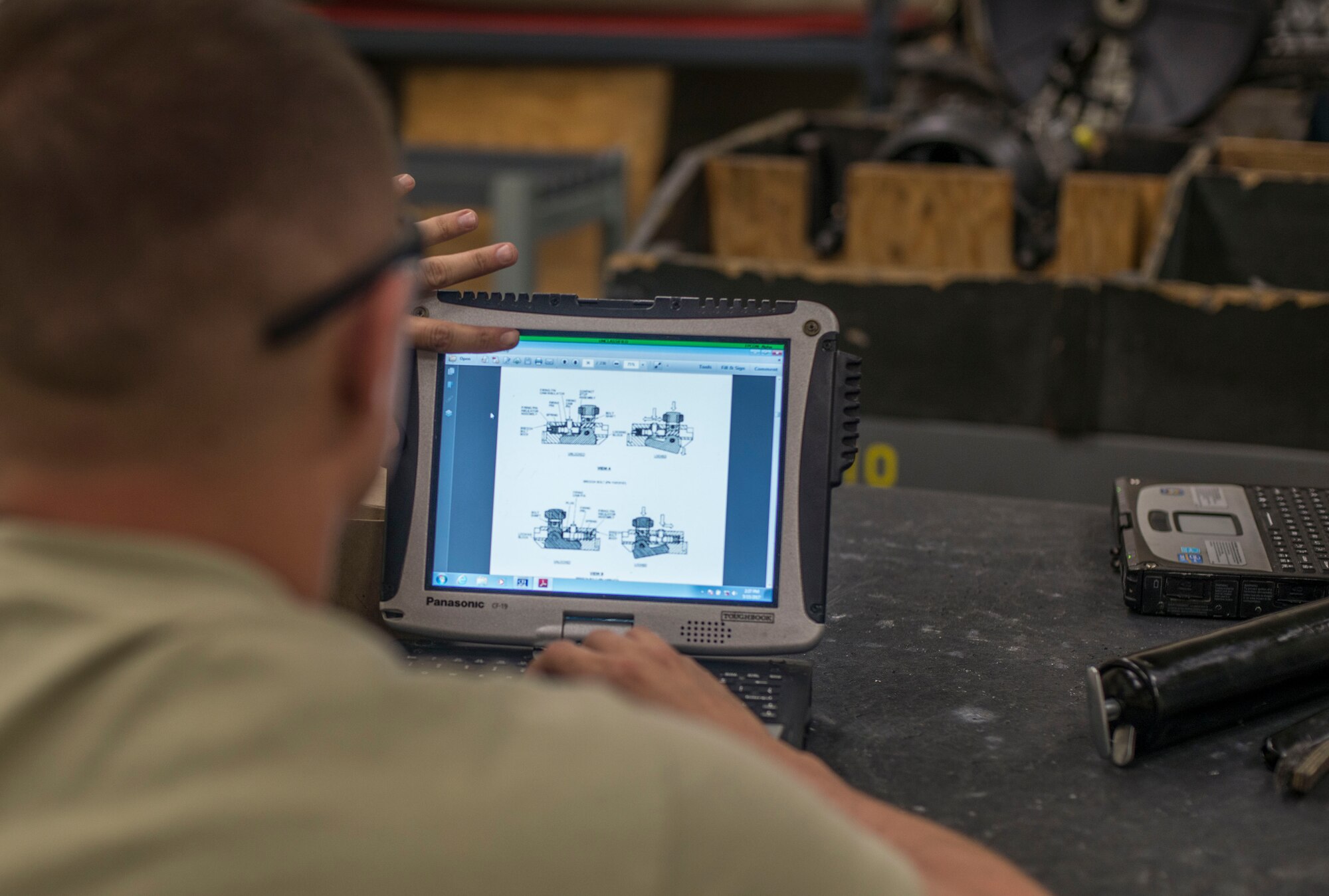 U.S. Air Force Senior Airman Joshua Wood, a 35th Maintenance Squadron armament technician, looks at a technical operation on the breach bolt at Kunsan Air Base, Republic of Korea, May 15, 2017. Breach bolts pull the round into the rotor, pulling it forward so it can fire then pulls it back. This was a part of an 18-month inspection where they completely break down the M61A1 20mm Gatling Gun and rebuild it, repairing or replacing any components that have been damaged. (U.S. Air Force photo by Senior Airman Brittany A. Chase) 