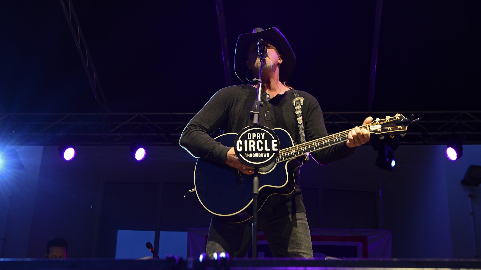 Grammy Award–nominated country music singer, Trace Adkins, belts out a tune during his performance for 1,200 Airmen and family members at Aviano Air Base, Italy, May 12, 2017. The performance is part of his 12th USO tour.  (Photo by U.S. Air Force Airman 1st Class Ryan Brooks)