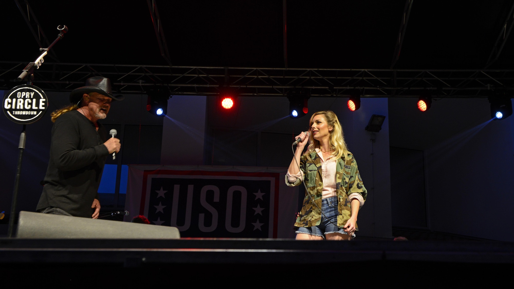 Trace Adkins is joined by his backup singer, Marion Grace, at center stage for a duet called “Every Time You Go Away” at Aviano Air Base, Italy, May 12, 2017. The USO concert was a free event for Airmen and their families. (Photo by U.S. Air Force Airman 1st Class Ryan Brooks)