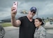Trace Adkins, country music singer, takes a picture with Senior Airman Elizabeth Sanchez, 31st Aircraft Maintenance Squadron weapons load crew member, during a USO Tour event at Aviano Air Base, Italy, May 12, 2017. Adkins is on his 12th USO tour and performed for service members in Spain and Italy.  (U.S. Air Force photo by Senior Airman Cory W. Bush)