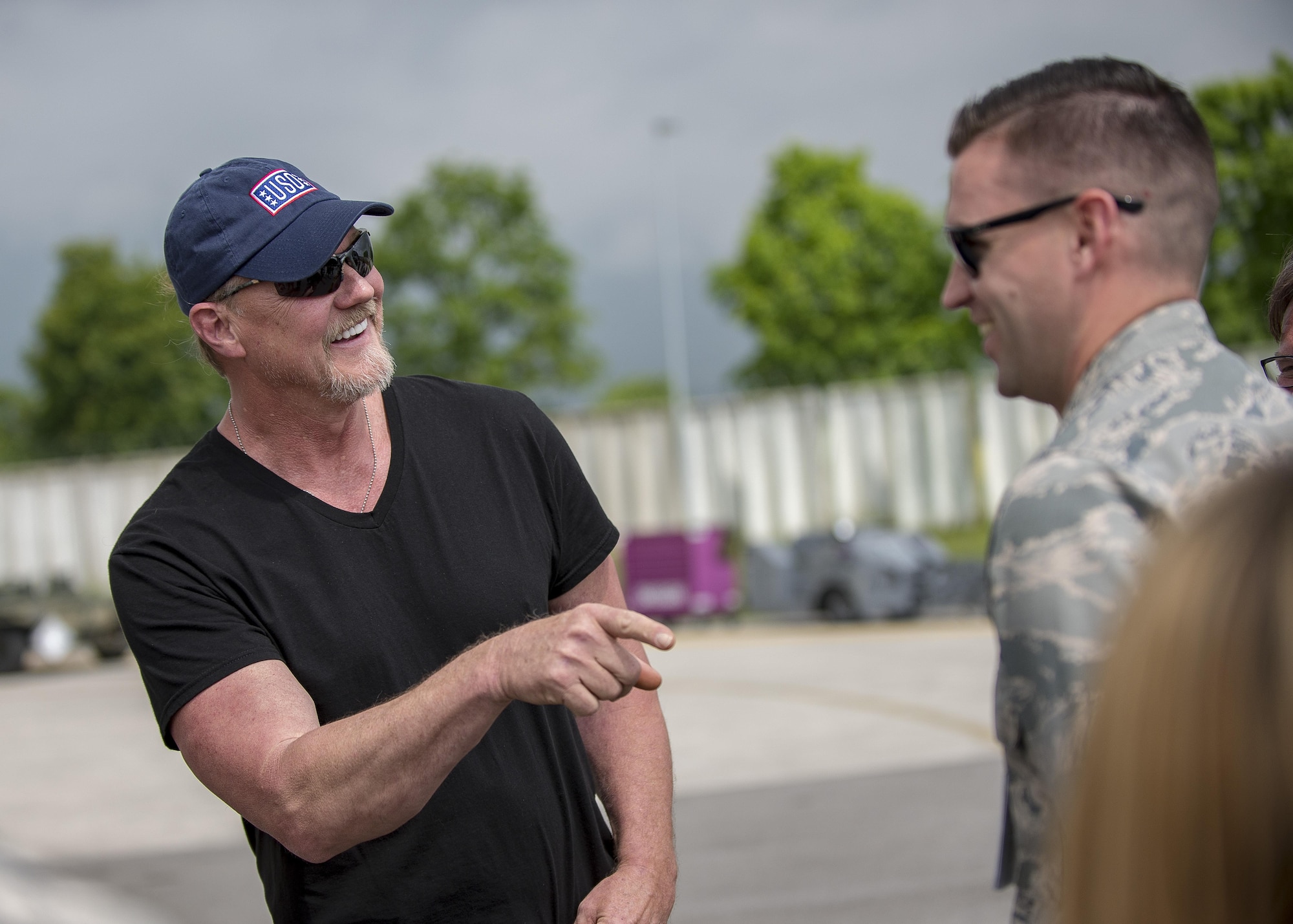 Trace Adkins, country music singer, laughs with Airmen during a USO Tour event at Aviano Air Base, Italy, May 12, 2017.  Adkins met with Airmen and took tours of base agencies prior to his concert later in the day. (U.S. Air Force photo by Senior Airman Cory W. Bush)