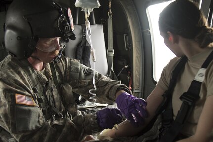 U.S. Army Staff Sgt. Robert Slater, flight medic, Charlie Company, 3rd Battalion, 126th Aviation Regiment, Vermont National Guard, administers an IV to a simulated causality, Camp Johnson, Colchester, Vt., May 6, 2017. Slater was participating in MEDEVAC training that incorporated ground medical units with their Air Ambulance unit. 