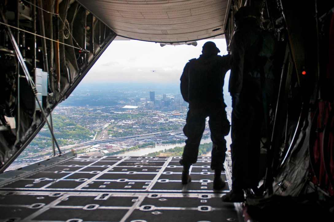 Air Force Command Sgt. Maj. Archie Branton watches from the back ramp of a C-130 Hercules aircraft as West Virginia Army National Guard members participate in a static line jump during the Wings Over Pittsburgh Open House, Pa., May 13, 2017. Branton is a loadmaster assigned to the 911th Air Wing and 758th Airlift Squadron. Army photo by Staff Sgt. Shaiyla Hakeem