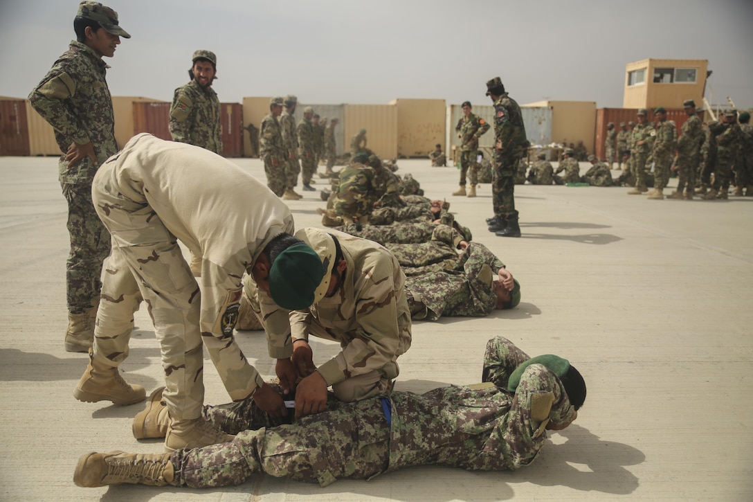 Afghan National Army soldiers with the 2nd Kandak, 4th Brigade, 215th Corps practice applying tourniquets at Camp Shorabak, Afghanistan, May 14, 2017. Instructors with the Helmand Regional Military Training Center, with guidance from Marine advisors assigned to Task Force Southwest, are preparing for an operational readiness cycle scheduled to begin May 20. More than 600 soldiers from 2nd Kandak, 4th Brigade will receive instruction and conduct training on warfighting functions to enhance security and stability in Helmand Province. (U.S. Marine Corps photo by Sgt. Lucas Hopkins)