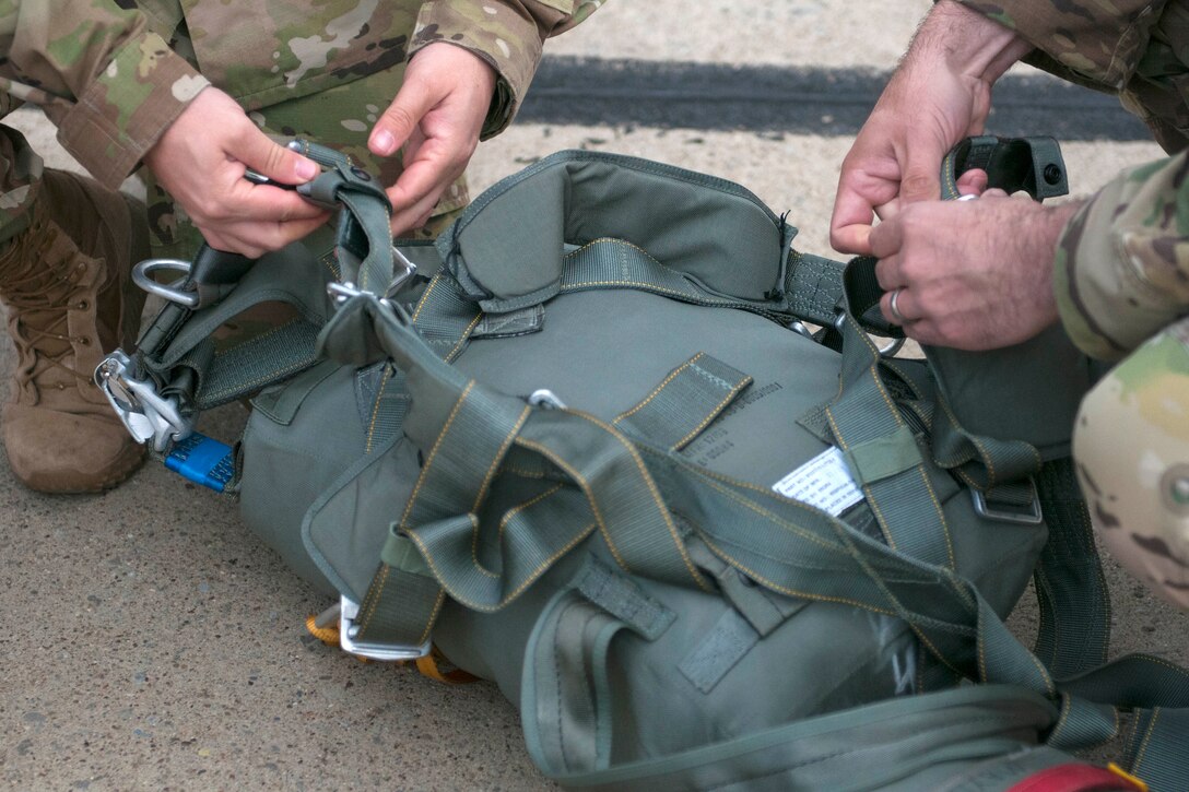 West Virginia Army National Guard members prepare their parachute gear for a static line jump from C-130 Hercules aircraft over Pittsburgh during the Wings Over Pittsburgh Open House, Pa., May 13, 2017. Army photo by Staff Sgt. Shaiyla Hakeem