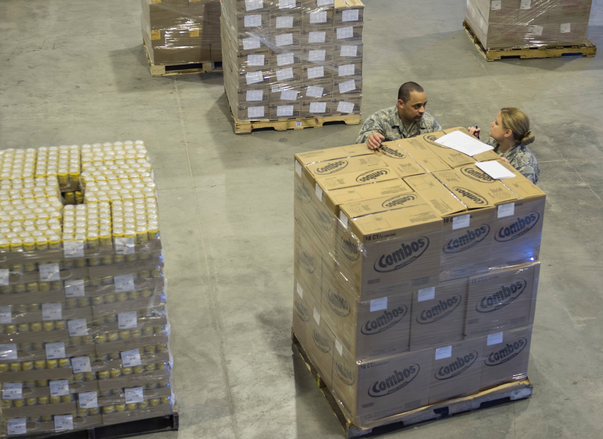 U.S. Air Force Tech. Sgt. Holli Woods, right, and Staff Sgt. Saul Garcia Qinones both with the 379th Expeditionary Force Support Squadron compare the shipping manifest to the order received at Al Udeid Air Base, Qatar May 10, 2017. Each week, a small team of Airmen work together to review shipments of produce, making sure the numbers matches the quantity received and that the quality of the produce meets standards. (U.S. Air Force photo by Tech. Sgt. Amy M. Lovgren)