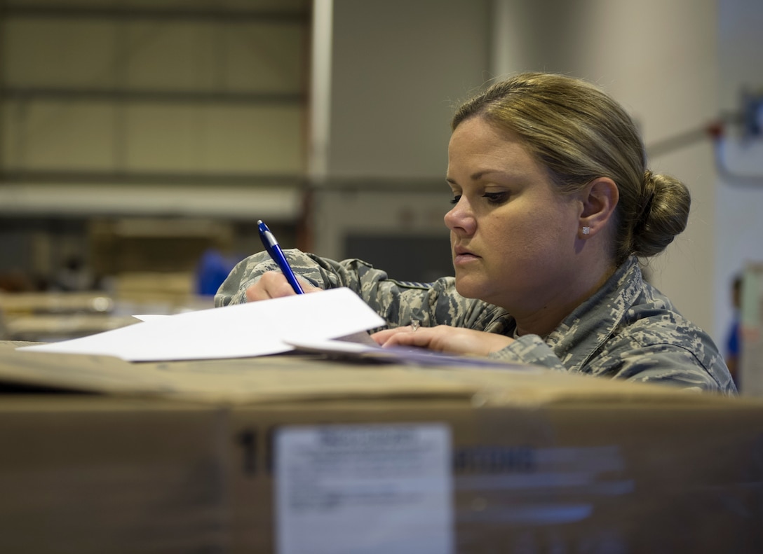 U.S. Air Force Tech. Sgt. Holli Woods, section chief with the 379th Expeditionary Force Support Squadron, checks the shipment manifest numbers against the shipment received at Al Udeid Air Base, Qatar May 10, 2017. Each week, a small team of Airmen work together to review shipments of produce, making sure the numbers matches the quantity received and that the quality of the produce meets standards. (U.S. Air Force photo by Tech. Sgt. Amy M. Lovgren)