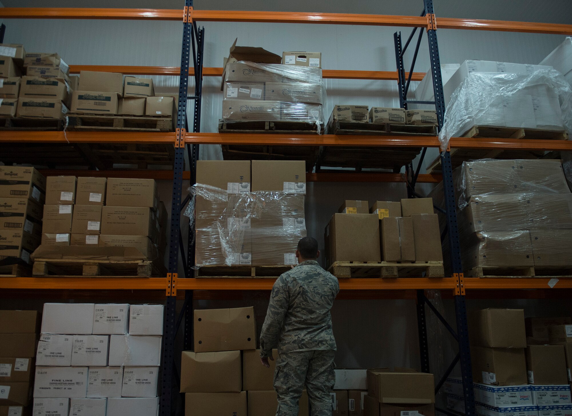 U.S. Air Force Staff Sgt. Saul Garcia Quinones, store manager with the 379th Expeditionary Force Support Squadron performs, a first-in first, out food rotation check at Al Udeid Air Base, Qatar May 10, 2017. The purpose of the first-in, first-out food rotation is to safeguard the food and decrease the chances of it getting spoiled. (U.S. Air Force photo by Tech. Sgt. Amy M. Lovgren)