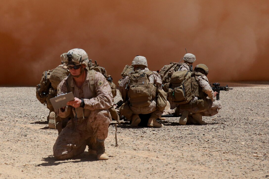 U.S. Marine Corps Capt. Tyler Tidwell, Company Commander for Baker Company, 1st Battalion, 7th Marine Regiment, Special Purpose Marine Air-Ground Task Force-Crisis Response-Central Command, evaluates the performance of his Marines as they prepare to board an MV-22 Osprey tiltrotor aircraft assigned to Marine Medium Tiltrotor Squadron 364 during a tactical recovery of aircraft and personnel exercise in Jordan, May 8 2017. This event supported Eager Lion 2017, a recurring multinational exercise designed to strengthen military-to-military relationships, increase interoperability between partner nations, and enhance regional security and stability. The SPMAGTF is a self-sustaining expeditionary unit, designed to provide a broad range of crisis response capabilities throughout the Central Command area of responsibility, using organic aviation, logistical, and ground combat assets. (U.S. Marine Corps photo by Cpl. Christopher Thompson)