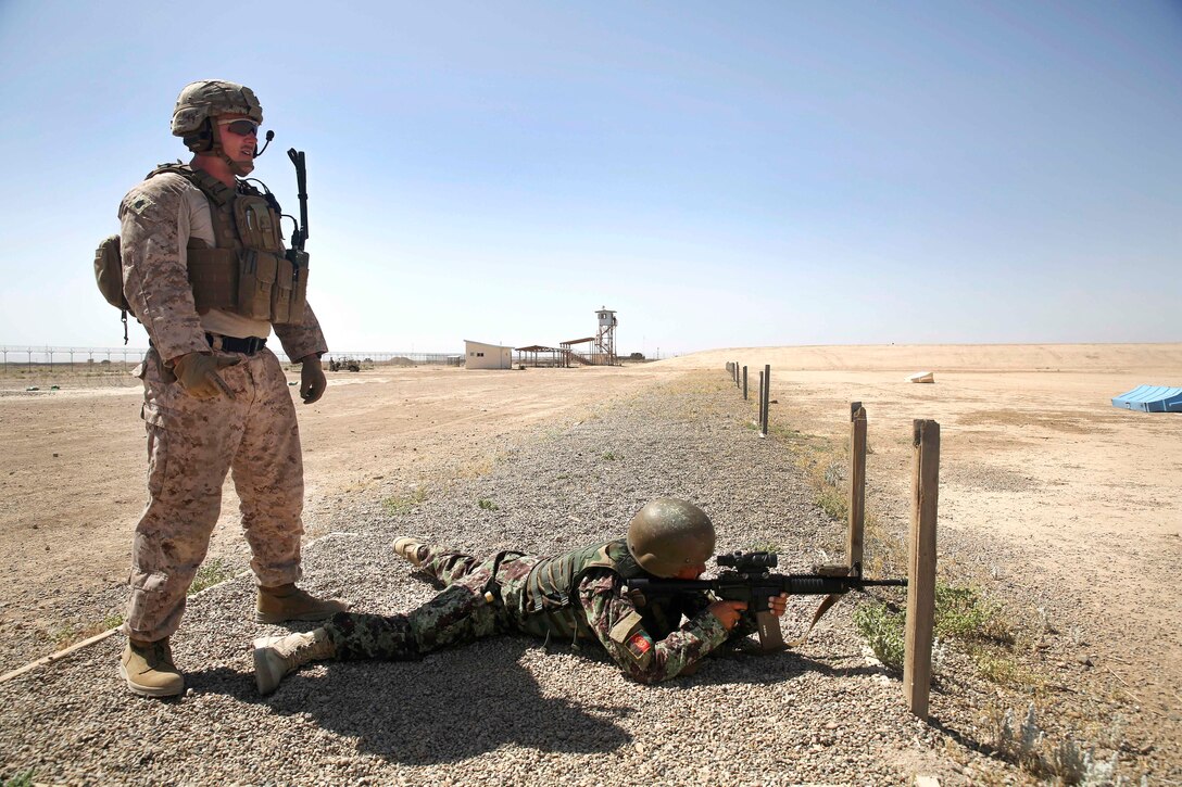 A U.S. Marine observes an Afghan soldier firing an M4 carbine at Camp Shorabak, Afghanistan, May 11, 2017. The Marine is assigned to Task Force Southwest. The Afghan soldier is assigned to the Helmand Regional Military Training Center. In preparation for the Task Force’s first operational readiness cycle, approximately 15 Marine advisors practiced marksmanship principles and proper range protocol with Afghan trainers. Marine Corps photo by Sgt. Lucas Hopkins
