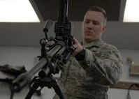 Airman 1st Class John Broda, 5th Security Forces Squadron defender, assembles an M249 light machine gun at the Combat Arms Training and Maintenance facility on Minot Air Force Base, N.D., May 8, 2017. To qualify on the weapon, Broda must properly disassemble and reassemble the M249. (U.S. Air Force photo/Airman 1st Class Dillon Audit)