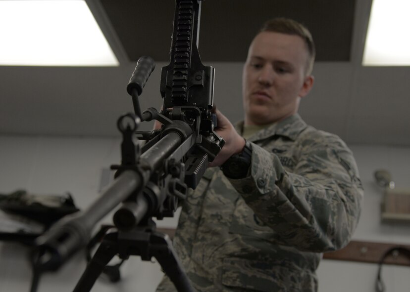 Airman 1st Class John Broda, 5th Security Forces Squadron defender, assembles an M249 light machine gun at the Combat Arms Training and Maintenance facility on Minot Air Force Base, N.D., May 8, 2017. To qualify on the weapon, Broda must properly disassemble and reassemble the M249. (U.S. Air Force photo/Airman 1st Class Dillon Audit)