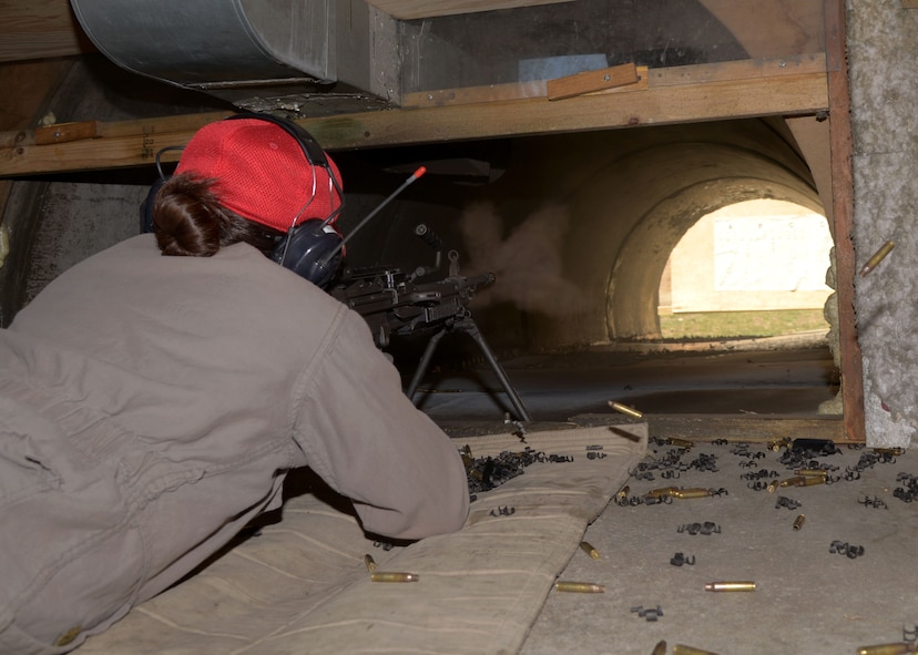 Senior Airman Samantha Kincaid, 5th Security Forces Squadron combat arms instructor, fires the M249 light machine gun in the heavy range at the Combat Arms Training and Maintenance facility on Minot Air Force Base, N.D., May 8, 2017. CATM instructors work with Airmen to practice properly loading and firing weapons. (U.S. Air Force photo/Airman 1st Class Dillon Audit)