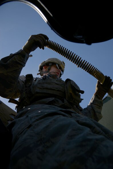 Airman 1st Class Kaleb Littau, 5th Security Forces Squadron defender, loads a magazine into a M249 light machine gun at the Combat Arms Training and Maintenance facility on Minot Air Force Base, N.D., May 8, 2017. CATM instructors direct Airmen when loading and firing a weapon from a Humvee’s turret. (U.S. Air Force photo/Airman 1st Class Dillon Audit)