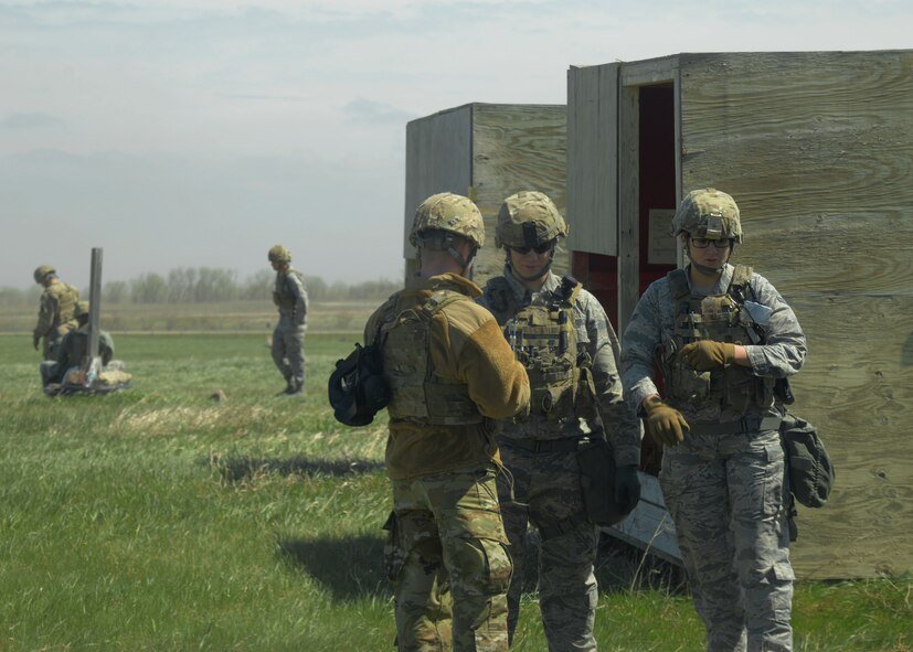 Airmen from the 5th Security Forces Squadron and 91st Security Forces Group wait to fire at the Combat Arms Training and Maintenance facility on Minot Air Force Base, N.D., May 8, 2017. Security forces Airmen must complete a progress check annually to verify their knowledge on the M249 light machine gun and other weapons. (U.S. Air Force photo/Airman 1st Class Dillon Audit)