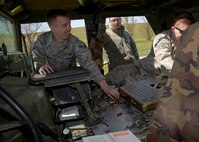 Airmen from the 5th Security Forces Squadron and 91st Security Forces Group collect M249 light machine gun ammo casings on Minot Air Force Base, N.D., May 8, 2017. The Combat Arms Training and Maintenance facility assists Airmen in weapon care and handling. (U.S. Air Force photo/Airman 1st Class Dillon Audit)