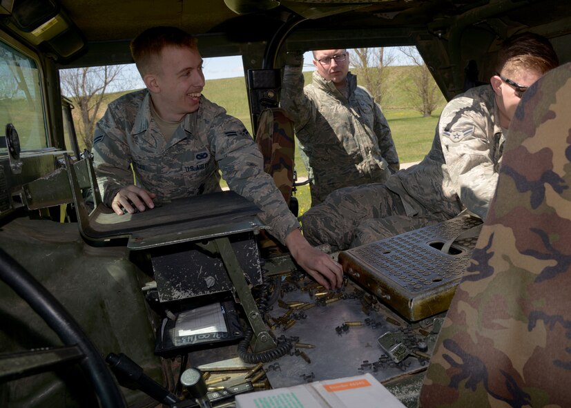 Airmen from the 5th Security Forces Squadron and 91st Security Forces Group collect M249 light machine gun ammo casings on Minot Air Force Base, N.D., May 8, 2017. The Combat Arms Training and Maintenance facility assists Airmen in weapon care and handling. (U.S. Air Force photo/Airman 1st Class Dillon Audit)