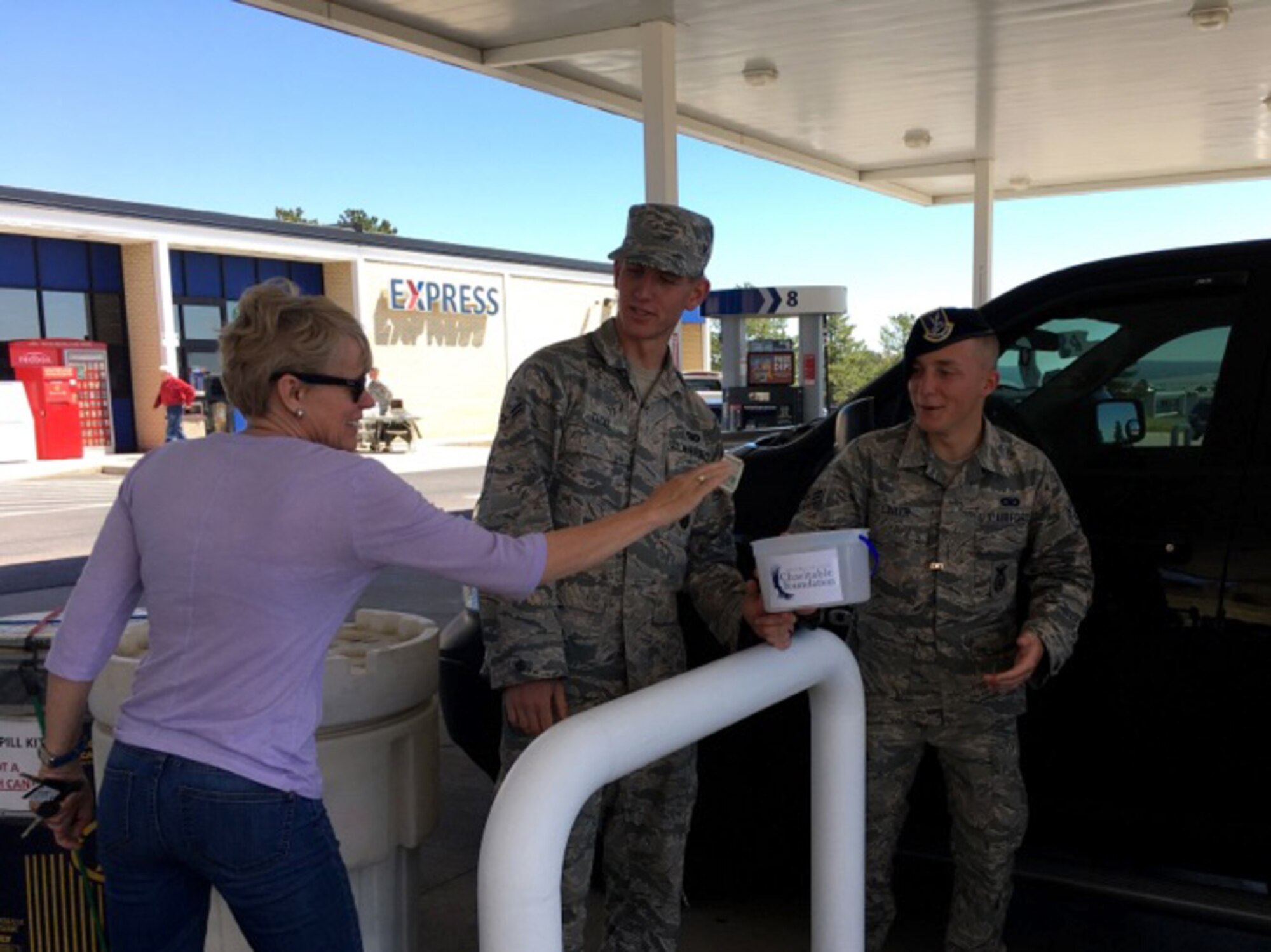 Defenders assigned to 10th Security Forces Squadron collect donations as part of the Air Force Assistance Fund campaign at the U.S. Air Force Academy, Colo., May 12, 2017. Seventeen volunteers from the squadron washed car windshields at the Academy Shopette to solicit donations. The squadron raised more than $3,300 for the AFAF. (Courtesy photo/Chief Master Sgt. Shadd McKee)
