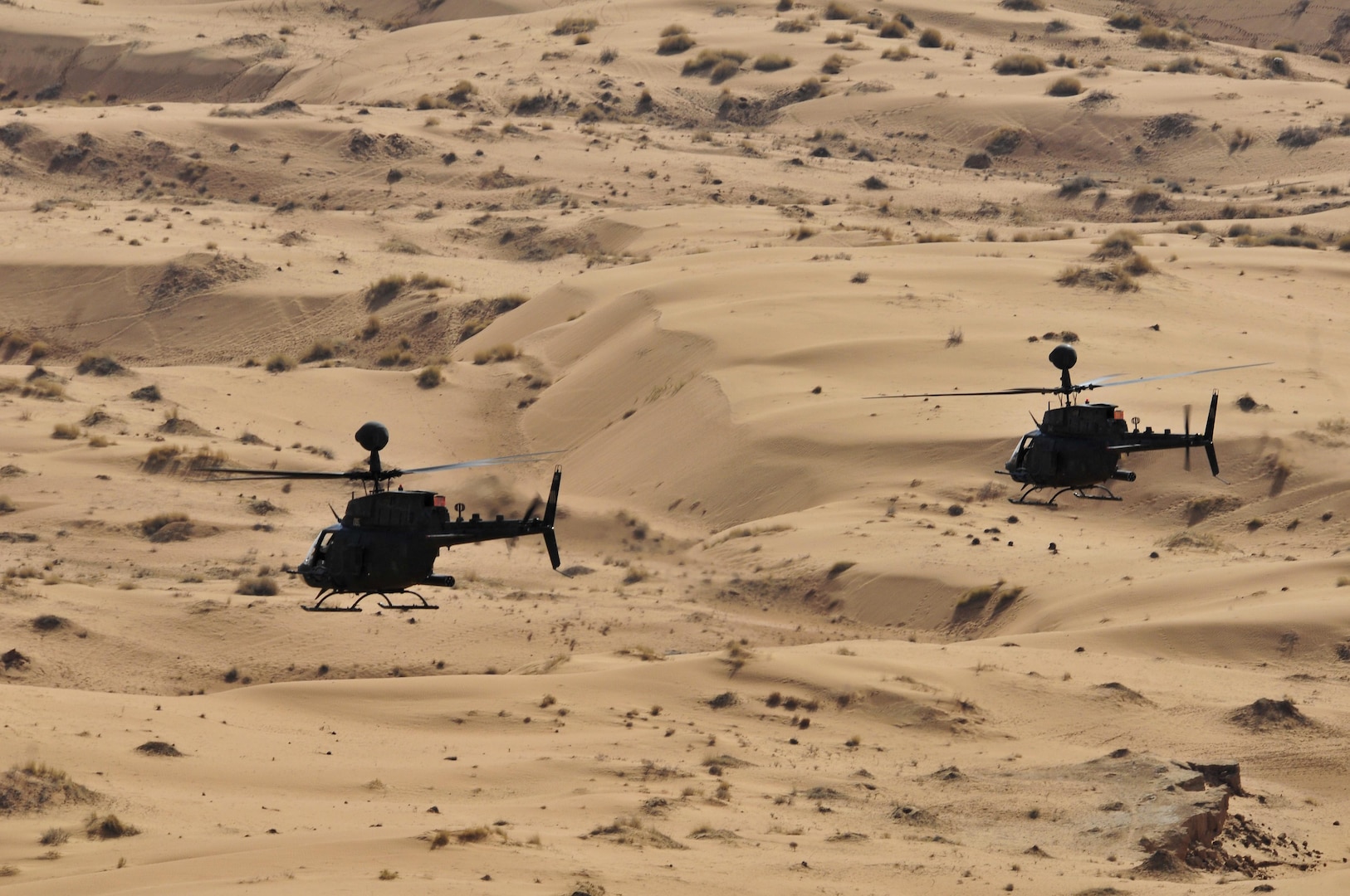 Two OH-58D Kiowa Warrior helicopters conduct aerial reconnaissance over the Red Desert in southern Afghanistan Jan. 31, 2011. 