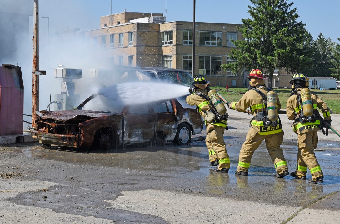 Indiana National Guard firefighters attached to the 719th Engineer Firefighter Detachment Headquarters practice their firefighting skills by extinguishing a burning vehicle at Muscatatuck Urban Training Center, May 13. (U.S. Army Reserve photo by Sgt. Clinton Massey, 206th Broadcast Operations Detachment)