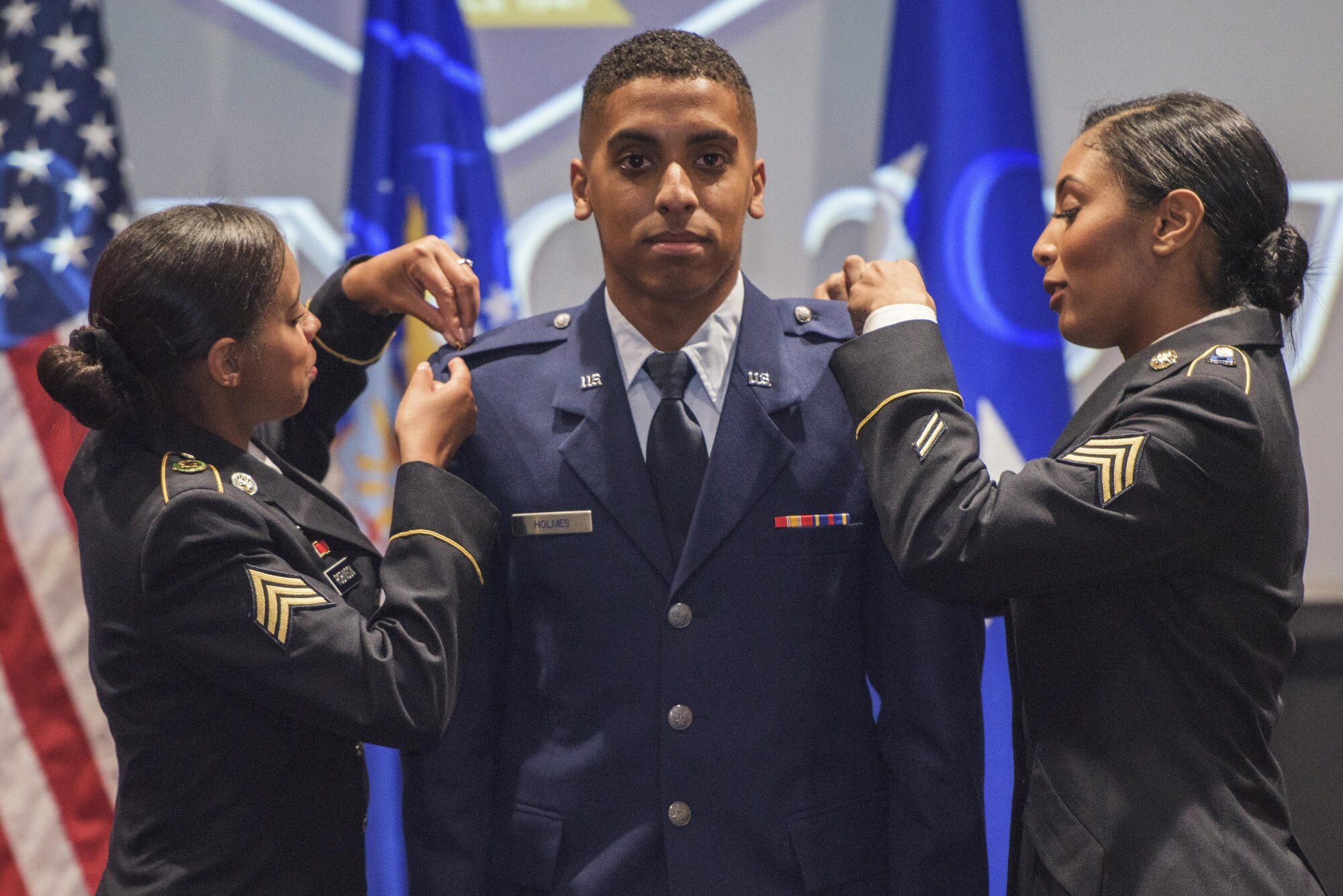 U.S. Air Force 2nd Lt. Jahvon Holmes, University of Texas San Antonio graduate, has his rank pinned on by his sisters May 12, 2017, at UTSA in San Antonio, Texas. Holmes was one of the 17 graduates in attendance, and is the first member of his family to commission in the Air Force who will begin his career in undergraduate pilot training. (U.S. Air Force photo by Senior Airman Stormy Archer)