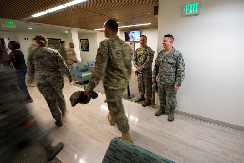 PETERSON AIR FORCE BASE, Colo. – Chief Master Sgt. Brendan Criswell, Air Force Space Command command chief, and Staff Sgt. Derrick Grinnell, 21st Civil Engineer Squadron fire inspector 2, assess the exiting speed of service members in the clinic during a fire drill at Peterson Air Force Base, Colo., May 11, 2017.  Grinnell and Criswell administered fire drills at various locations on base as part of the monthly inspection process. (U.S. Air Force photo by Airman 1st Class Dennis Hoffman)