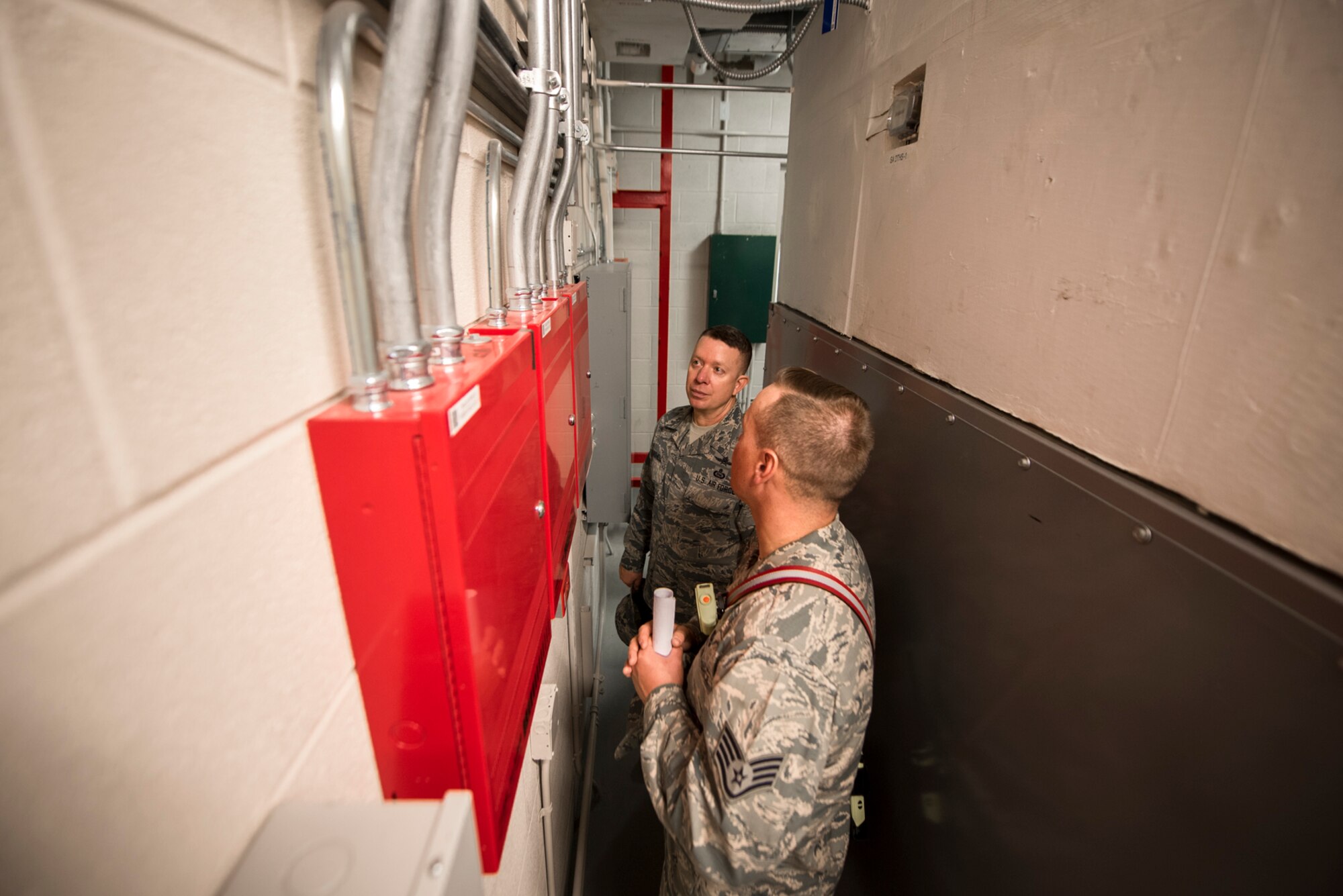 PETERSON AIR FORCE BASE, Colo. – Staff Sgt. Derrick Grinnell, 21st Civil Engineer Squadron fire inspector 2, explains to Chief Master Sgt. Brendan Criswell, Air Force Space Command command chief, the process of inspecting and assessing any fire hazards in a mechanical room at Peterson Air Force Base, Colo., May 11, 2017. Criswell hopes to expand his shadowing program and glimpse into the lives of enlisted members and their duties here on Peterson AFB, as well as other space wings in the command. (U.S. Air Force photo by Airman 1st Class Dennis Hoffman)