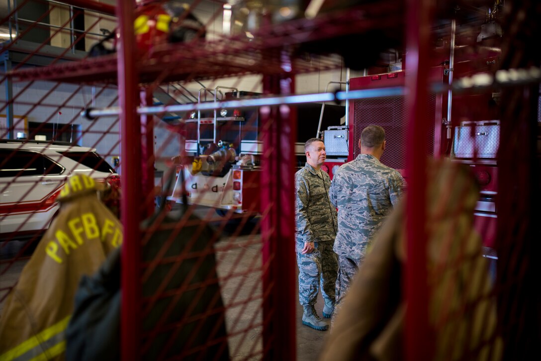 PETERSON AIR FORCE BASE, Colo. – Chief Master Sgt. Brendan Criswell, Air Force Space Command command chief, tours the Fire Station with Staff Sgt. Derrick Grinnell, 21st Civil Engineer Squadron fire inspector 2, at Peterson Air Force Base, Colo., May 11, 2017.  Criswell spent the day shadowing Grinnell on the duties of a fire inspector at Peterson AFB. (U.S. Air Force photo by Airman 1st Class Dennis Hoffman)