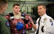 Sergeant Kenneth Gill, Philadelphia Police Department Recruit Training Unit, right, speaks with Senior Airman Nicholas Christopher, left and Staff Sgt. Joshua Floyd, center, both 436th Security Forces Squadron Ravens, May 11, 2017, at Dover Air Force Base, Del. The Airmen conducted a Redman suit training demonstration for their civilian counterparts at the Ravens’ training section. (U.S. Air Force photo by Roland Balik)