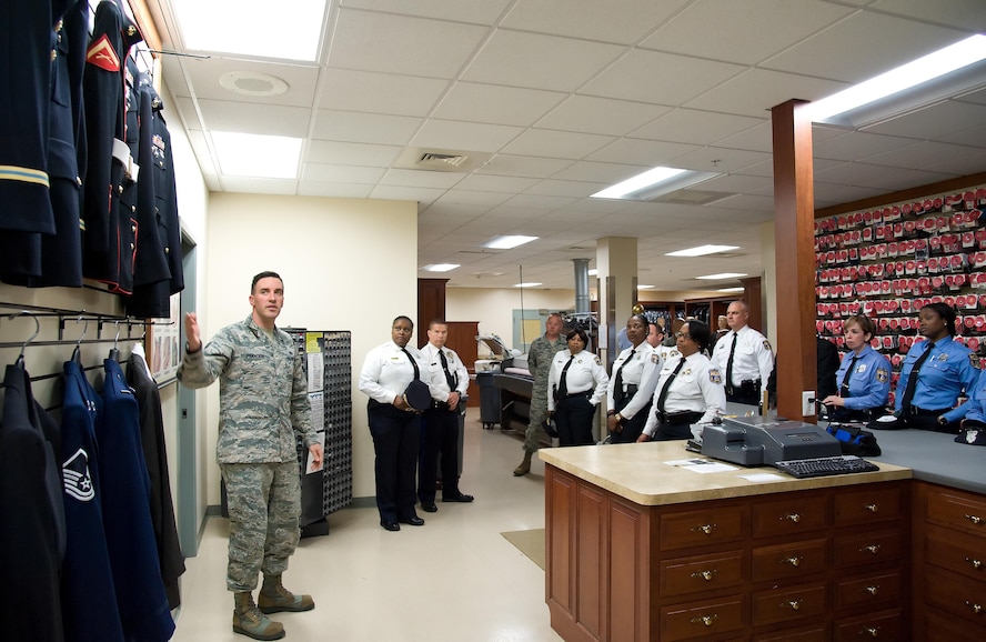 Staff Sgt. Guiseppe Francioni, Air Force Mortuary Affairs Operations uniform section, explains to members of the Philadelphia Police Department, Philadelphia, Pa., all the service uniforms carried in the section for fallen service members, May 11, 2017, at AFMAO on Dover Air Force Base, Del. Francioni mentioned that fallen service members are provided brand-new dress uniforms with all the proper decorations and medals prior to departing AFMAO. (U.S. Air Force photo by Roland Balik)
