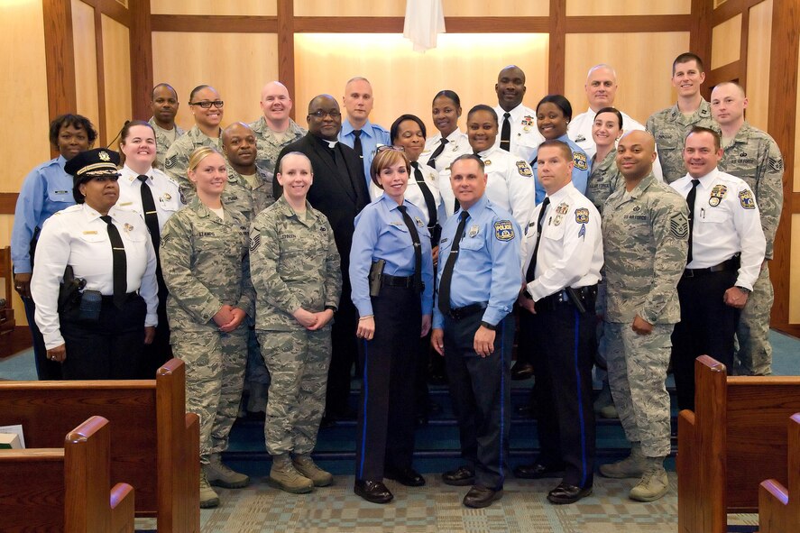 Members of the 436th Security Forces Squadron, Philadelphia Police Department, Philadelphia, Pa., and Base Chapel staff, pose for a group photo May 11, 2017, at Dover Air Force Base, Del. Fifteen members of the police department toured the 436th SFS, Air Force Mortuary Affairs Operations and Base Chapel during their five-hour visit to the base. (U.S. Air Force photo by Roland Balik)