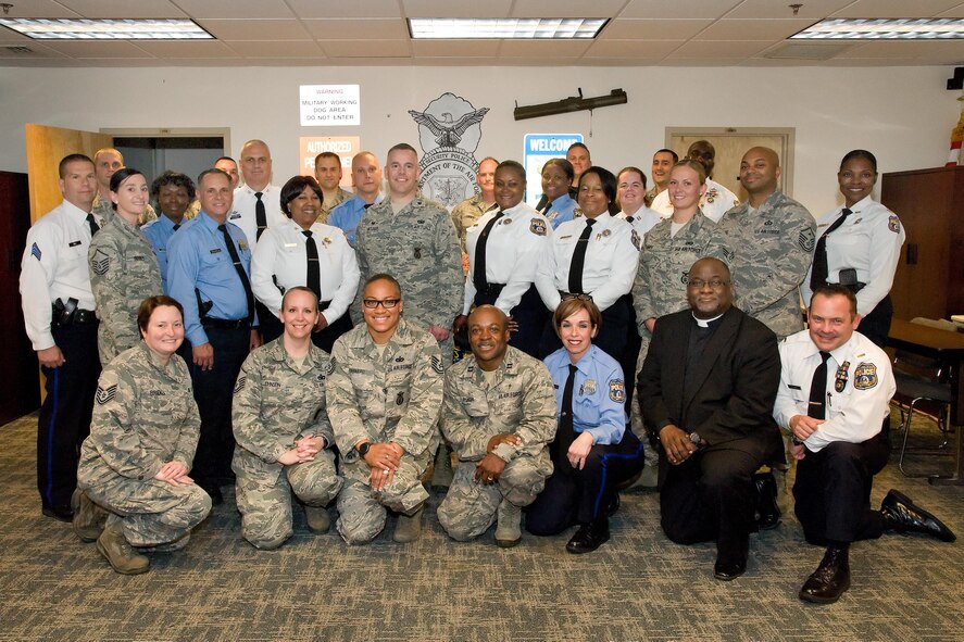 Members of the 436th Security Forces Squadron and Philadelphia Police Department, Philadelphia, Pa., pose for a group photo May 11, 2017, at building 910 on Dover Air Force Base, Del. Fifteen members of the police department received a mission brief, observed both a military working dog and a Raven Redman suit demonstration, a tour of Air Force Mortuary Affairs Operations and the Base Chapel. (U.S. Air Force photo by Roland Balik)