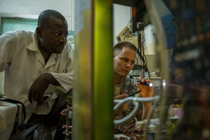 Chadian Lt. Djenaissem Bekoutou, a biomedical technician, and U.S. Army Reserve Chief Warrant Officer 2 Doug Sires, a health services maintenance technician, assigned to 3rd Medical Command Deployment Support in Forest Park, Ga., run diagnostics on a c-arm machine during Medical Readiness Training Exercise 17-3 at the Military Teaching Hospital in N'Djamena, Chad, May 10. The mutually beneficial exercise offers opportunities for the partnered militaries to share best practices and improve medical treatment processes. (U.S. Army Africa photo by Staff Sgt. Shejal Pulivarti)