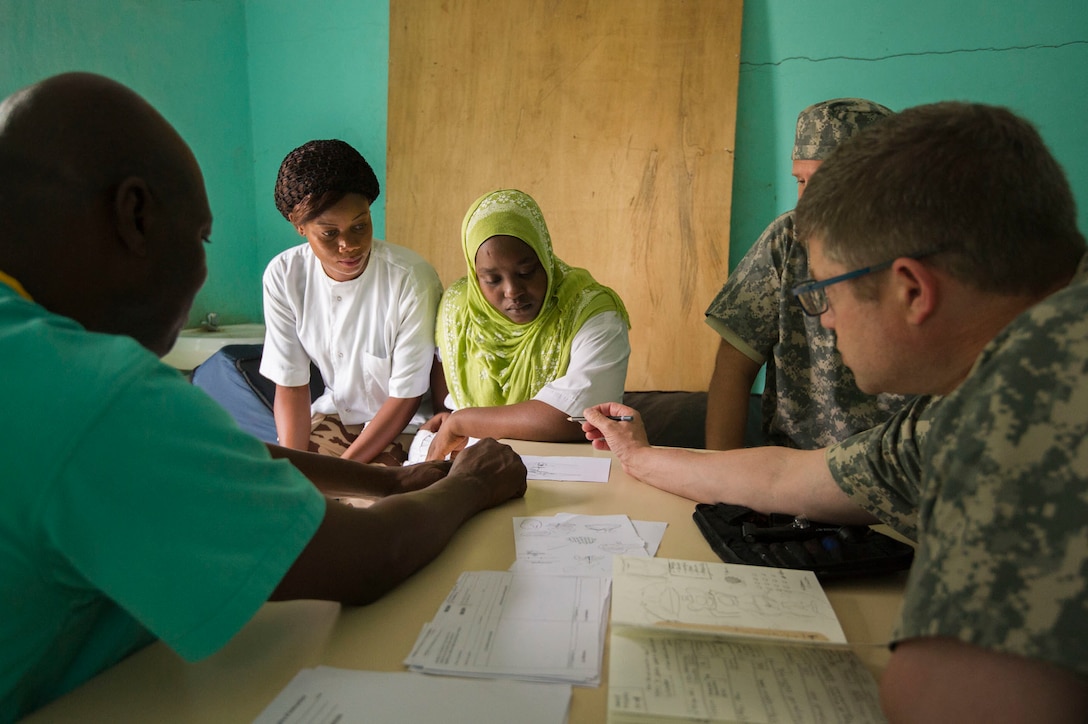 U.S. Army Reserve Col. Peter Ray, pediatric plastics and reconstructive surgeon, assigned to 3rd Medical Command Deployment Support in Forest Park, Ga., explains the construction of a knee using a sketch during Medical Readiness Training Exercise 17-3 at the Military Teaching Hospital in N'Djamena, Chad, May 10. The mutually beneficial exercise offers opportunities for the partnered militaries to share best practices and improve medical treatment processes. (U.S. Army Africa photo by Staff Sgt. Shejal Pulivarti)