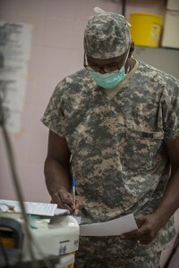 U.S. Army Reserve Maj. Christopher Sims, a nurse anesthetist, assigned to 3rd Medical Command Deployment Support in Forest Park, Ga., documents the patients vitals during a thyroidectomy at Medical Readiness Training Exercise 17-3 at the Military Teaching Hospital in N'Djamena, Chad, May 12. The mutually beneficial exercise offers opportunities for the partnered militaries to share best practices and improve medical treatment processes. (U.S. Army Africa photo by Staff Sgt. Shejal Pulivarti)