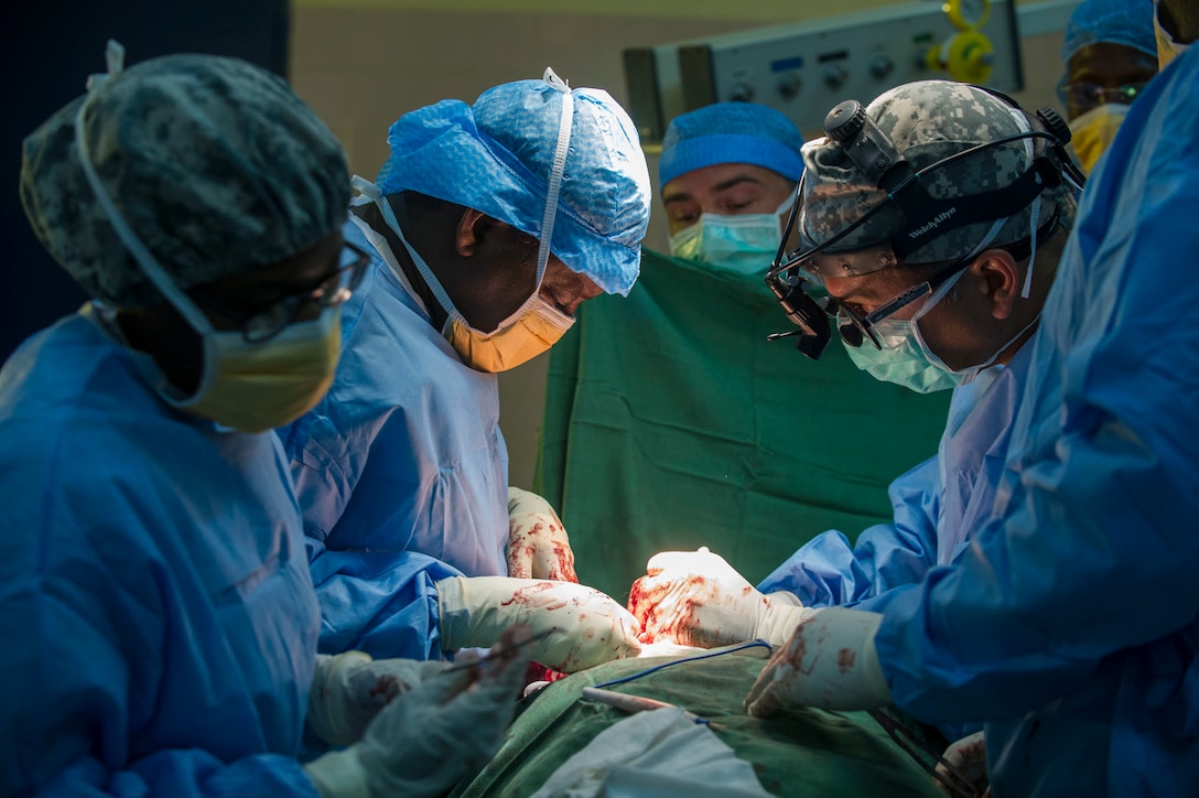 Chadian Col. Bakhit Saleh Harane, surgeon, and U.S. Army Reserve Col. Christopher Sinha, an ear, nose and throat surgeon perform a thyroidectomy during Medical Readiness Training Exercise 17-3 at the Military Teaching Hospital in N'Djamena, Chad, May 15. The mutually beneficial exercise offers opportunities for the partnered militaries to share best practices and improve medical treatment processes. (U.S. Army Africa photo by Staff Sgt. Shejal Pulivarti)