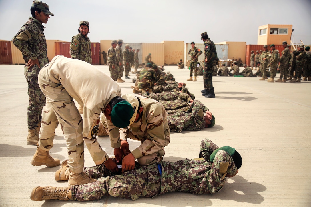 Afghan soldiers practice applying tourniquets to mock casualties at Camp Shorabak, Afghanistan, May 14, 2017. U.S. Marine advisors assigned to Task Force Southwest provided training and mentorship to the Afghan trainers. Marine Corps photo by Sgt. Lucas Hopkins