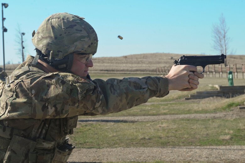 Airman Ryan Benjamin, 91st Missile Security Forces Squadron response force member, fires an M9 pistol at Camp Grafton South, Devil’s Lake, N.D., May 4, 2017. The 91st Security Forces Group Global Strike Challenge team trained in preparation for the upcoming competition, which challenges security forces tactics, job knowledge and weapons firing. (U.S. Air Force photo/Airman 1st Class Jessica Weissman)