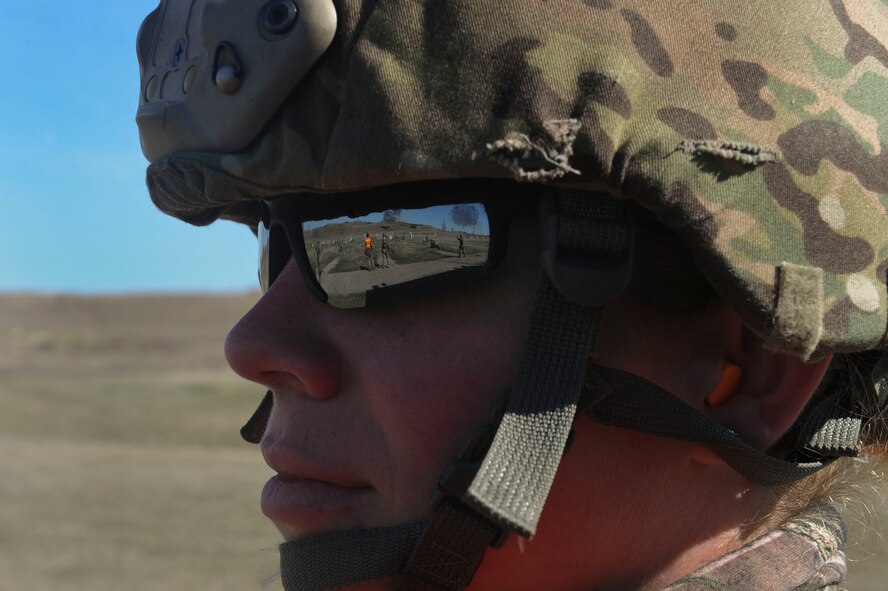 Senior Airman Angela Lage, North Dakota Air National Guard 219th Security Forces Squadron combat arms member, watches Airmen fire at Camp Grafton South, Devil’s Lake, N.D., May 4, 2017. The team trained in preparation for the upcoming competition, which challenges security forces tactics, job knowledge and weapons firing. (U.S. Air Force photo/Airman 1st Class Jessica Weissman)